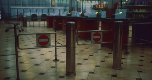 Entrance Barriers and a Deserted Space Emphasize Stillness in the Terminal