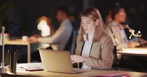 Young Professional Caucasian Office Manager Woman Using Laptop and Smartphone Performing Job Duties