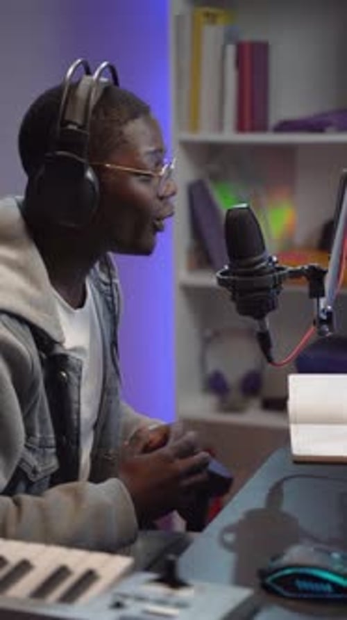 Vertical Video of Young Black Man Streaming Online Broadcast Live Podcast in Home Sound Studio Set
