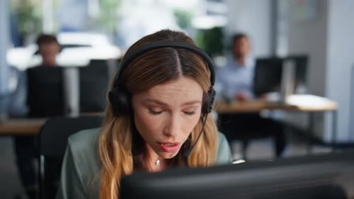Tech Support Operator Helping Client Wearing Headset in Office Space Closeup