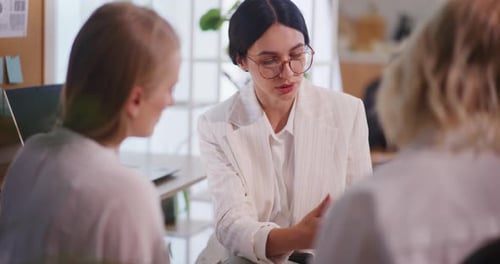 Three Women Meeting in a Bright Office
