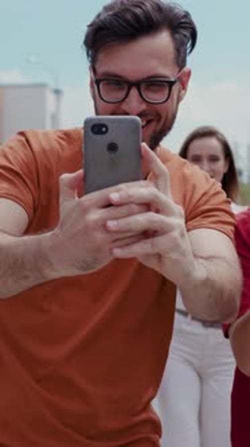 Group of Friends Taking Pictures Using Their Phones
