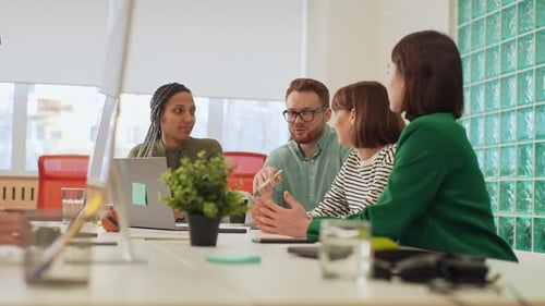 Team Discussing Strategy in Bright Modern Office