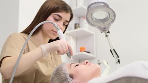 Professional Beautician Woman Doing Hydrafacial Procedure in Cosmetology Clinic