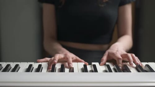 Woman Plays Piano Keyboard Close Up Indoors
