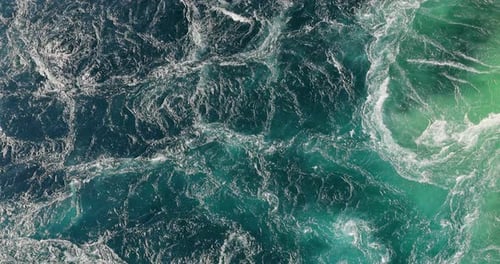 Blue waves of water of the river and the sea meet each other during high tide and low tide.