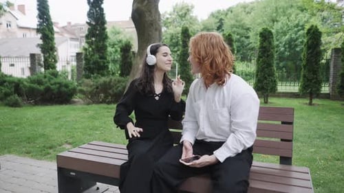 In a Park a Woman Dances Joyfully Later Joining a Man on a Bench