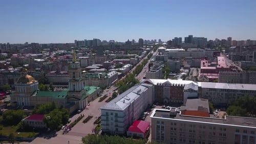 Helicopter view of the city. Clip. Nice sunny weather over the city with houses