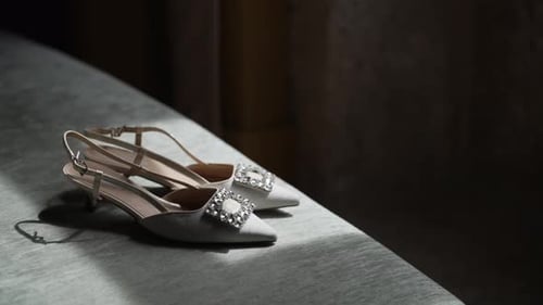 Elegant bridal shoes on a soft couch