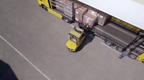 Forklift Loading Truck in Logistics Yard Aerial