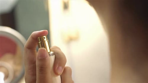 Woman Spraying Perfume On Her Neck Beauty Bottle Elegant close up. femininity concept
