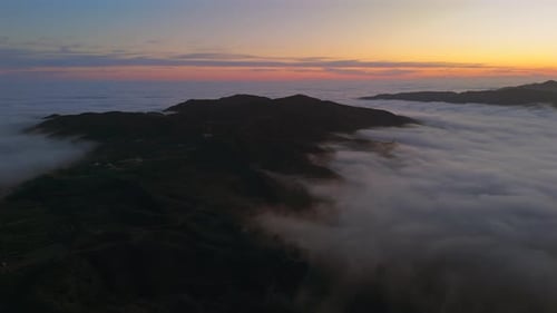 Breathtaking Aerial Views of Malibu Mountains Captured at Sunset Over Foggy Clouds
