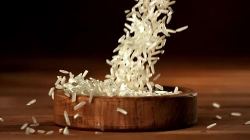 White Rice Falls Into a Wooden Bowl Filmed on a Highspeed Camera at 1000 Fps