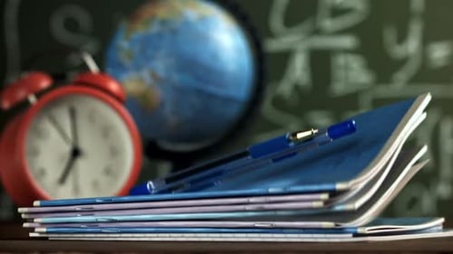 Notebooks and Pens Fall on the School Desk Filmed on a Highspeed Camera at 1000 Fps