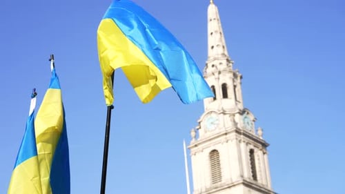 Ukrainian Flags Waving near City Building