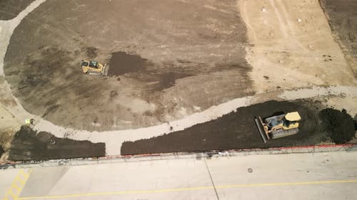 Aerial View of Construction Workers Operate Bulldozers While Building New Homes and Road