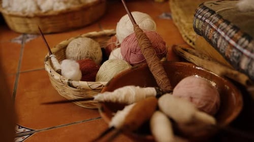 Handspun yarn balls and wooden spindles in a Guatemalan textile studio