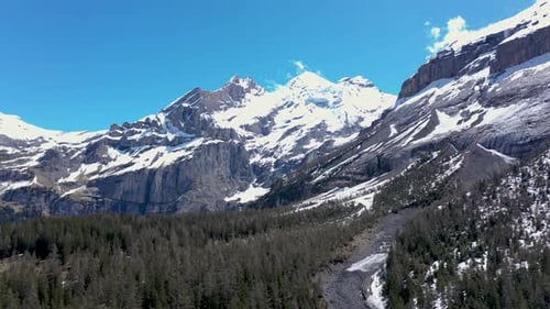 Drone flight over a beautiful alpine glacier valley and vast mountainous landscape. Kandersteg, Swit