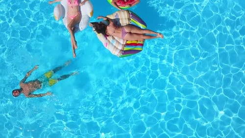 Aerial View of People Relaxing in Swimming Pool