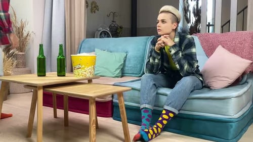 Two Friends Watching Television on Couch at Home