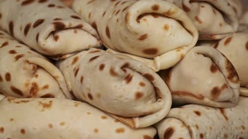 Stack of Golden Brown Rolled Pancakes