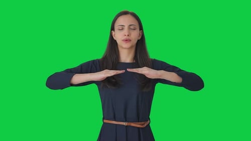 Indian girl taking long breaths Green screen