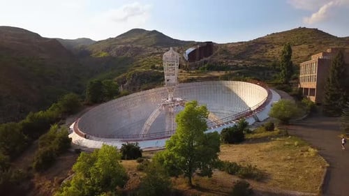 Low Aerial Shot of Mount Aragats Radio Optical Telescope's Herouni Mirror on a Sunny Evening with Pe