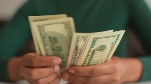 Closeup Top View Shot of Unrecognizable African Woman Counting Dollar Bills Closeup of Black Female