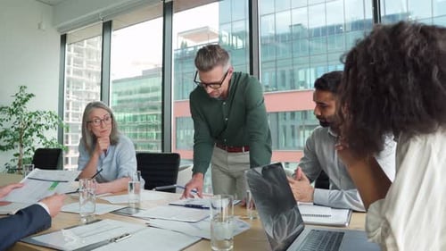 Business Professionals Discussing Documents at Conference Table