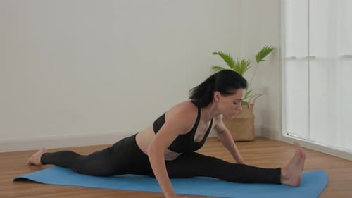 Woman Does Splits on a Yoga Mat