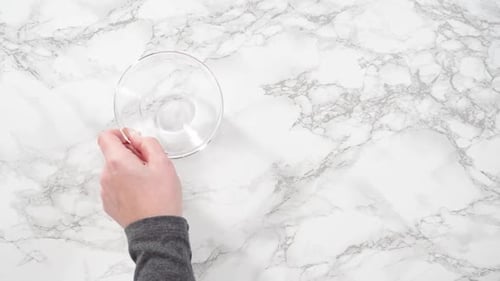 Adding Butter and Egg to Bowls on Marble