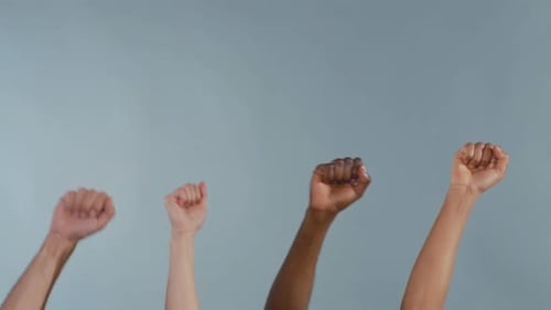 Group of Individuals United with Clenched Fists Signifying Empowerment and Collective Justice Demand