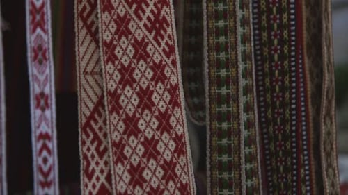 colorful woven garters and waistbands with folk patterns at the craft market