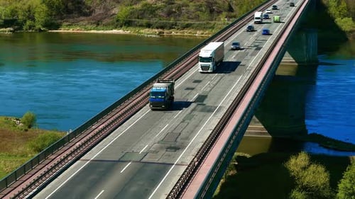 Truck with Cargo Van Trailer Driving on Bridge Lorry with Box Trailer Moving Across Overpass