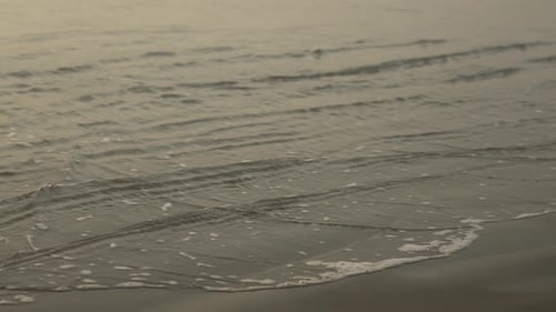 Gentle Waves Washing Ashore at Sunrise or Sunset