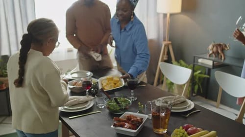 Family Setting Table in Bright Dining Room