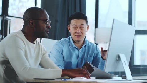 Men Working Together and Shaking Hands in Office