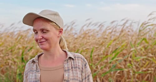 Woman Farmer Smiling in Golden Cornfield