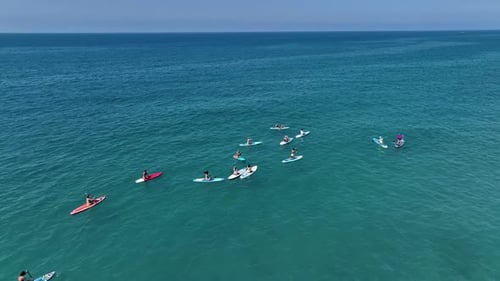 Aerial View Paddleboarders Enjoying the Calm Waters of the Bay During a SUP Festival