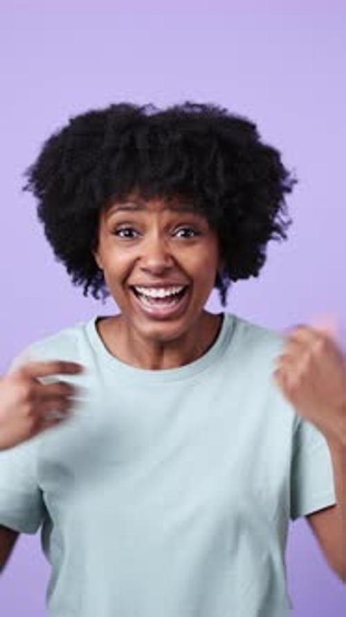 Excited Woman Receiving Good News on Purple Background