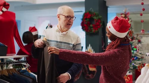 Saleswoman Assists Senior Man Selecting Blazer for Christmas