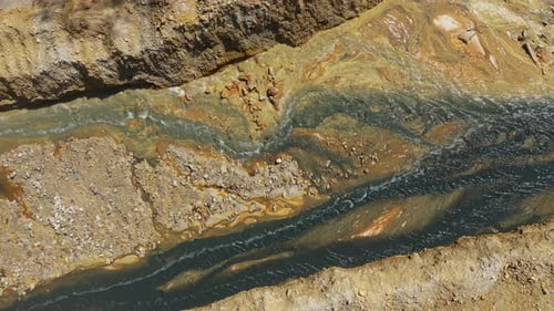 Aerial view of flowing lime and acid mine drainage reaction, water treatment, water remediation