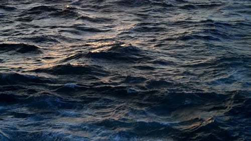 Motion Of Waves In The Sea During Golden Hour. - close up shot