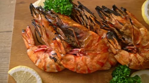 Appetizing Grilled Prawns on Wooden Board with Lemon
