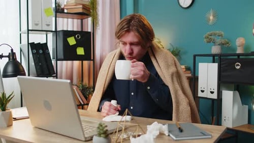 Sick Ill Young Businessman Suffering From Cold Flu or Allergy Wipes Snot Working on Laptop at Office