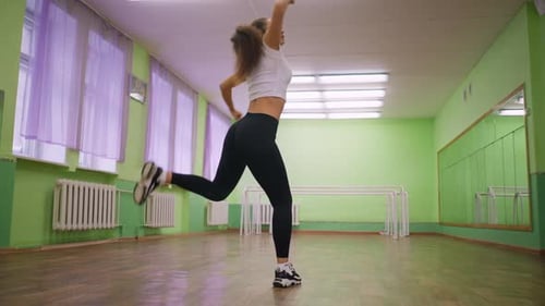 Woman in White Top and Black Leggings Dancing Athletic Workout Indoors