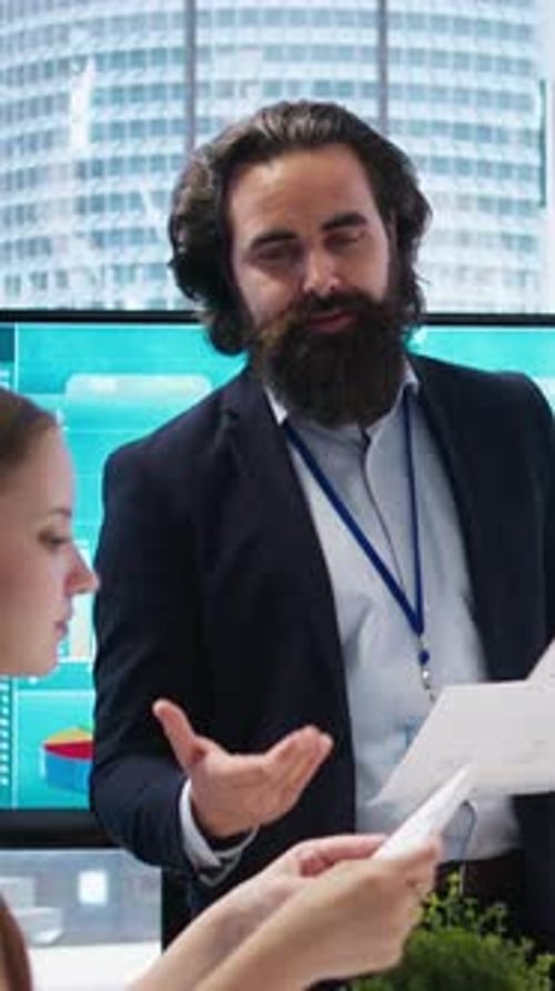 Vertical Video Financial Advisor Showing Statistical Graphs on Big Screen to Customers