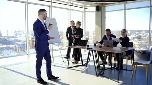 Group business meeting in stylish office. Handsome businessman thinking about new project.