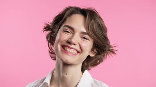 Smiling Young Woman with Wavy Hair in Close-Up
