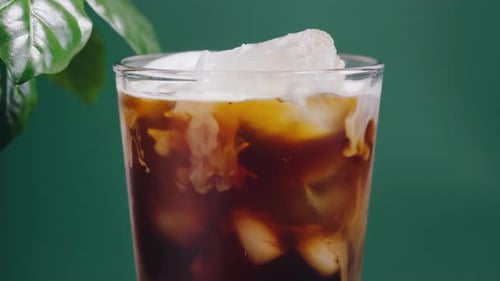 Cream Poured into Glass of Iced Coffee
